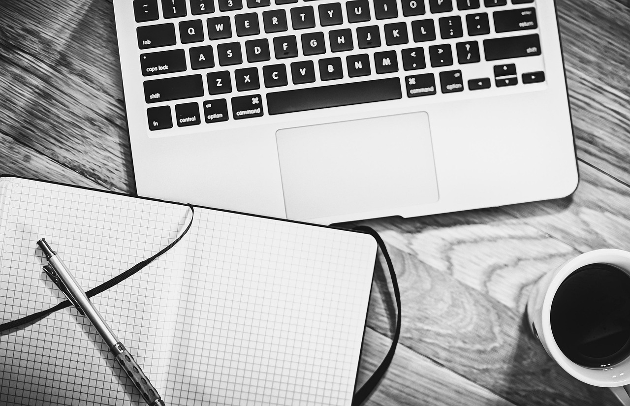 Computer, notebook, coffee — 3PL Logistics: How to Choose a 3PL Warehousing Solution