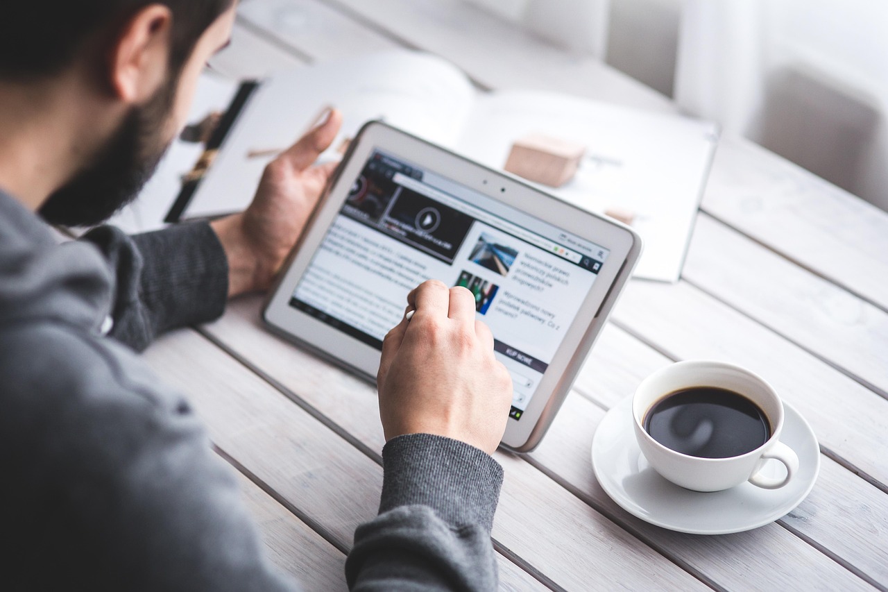 Man, reading, touchscreen — Increase Your Earnings: Tips for Construction Foremen to Get Paid More