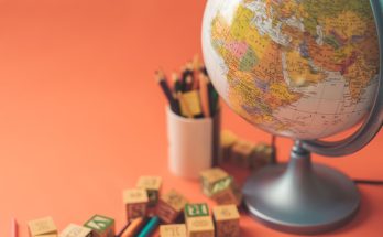 Globe and educational tools on a vibrant background