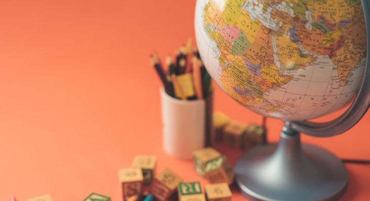 Globe and educational tools on a vibrant background